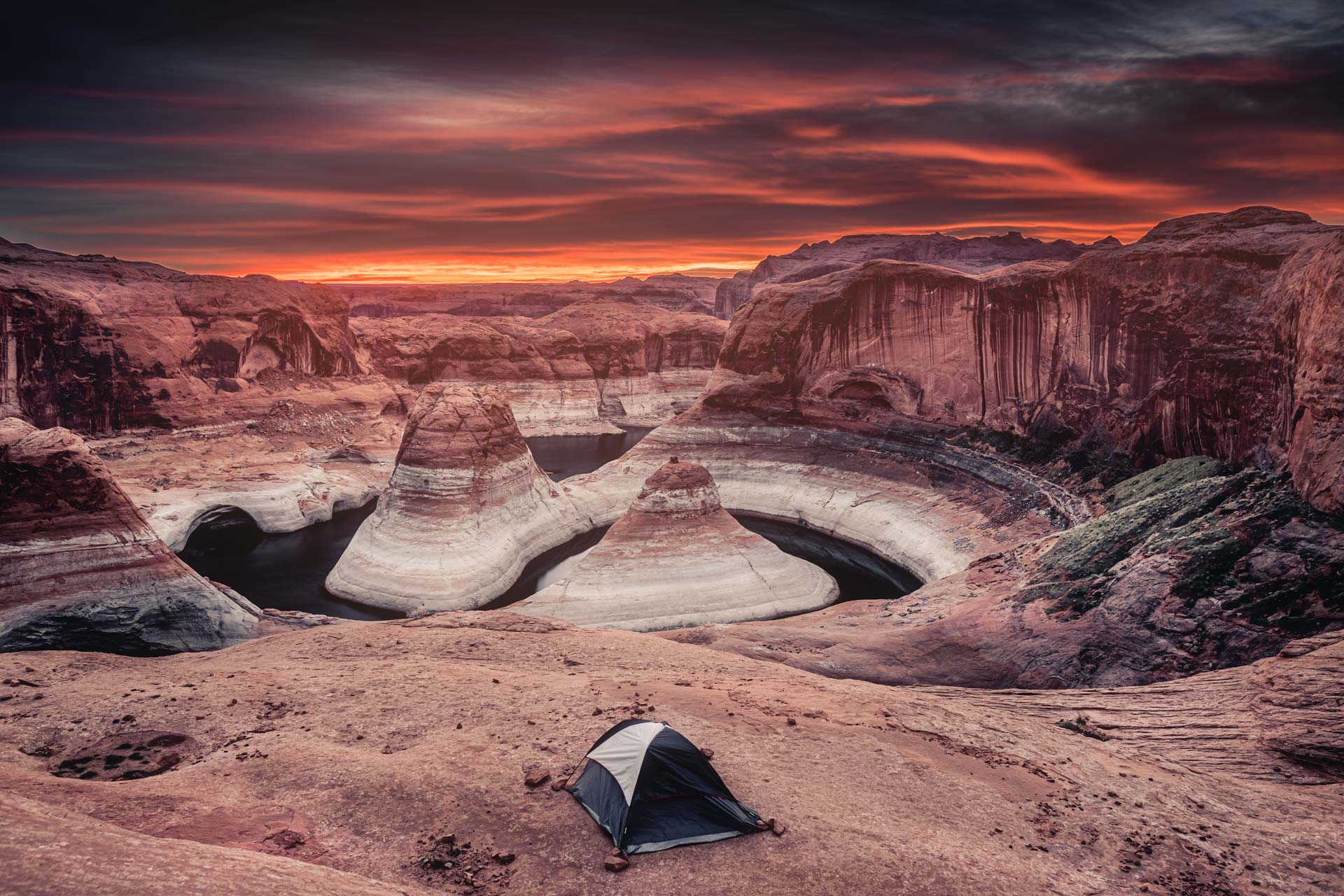 Sunrise at Reflection Canyon with a tent.